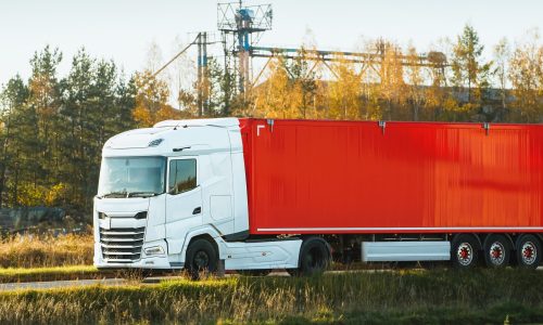red-freight-truck-countryside-road.jpg